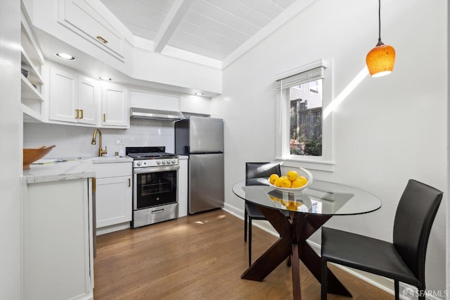 kitchen featuring extractor fan, hanging light fixtures, stainless steel appliances, white cabinets, and dark hardwood / wood-style flooring