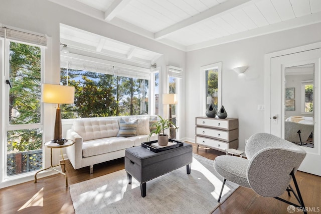 sunroom featuring beam ceiling