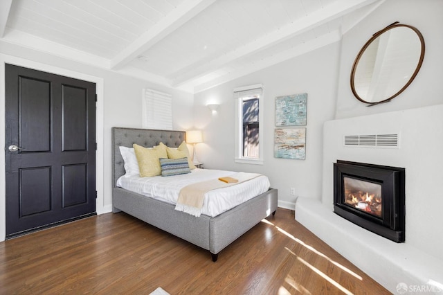 bedroom with dark hardwood / wood-style floors and lofted ceiling with beams