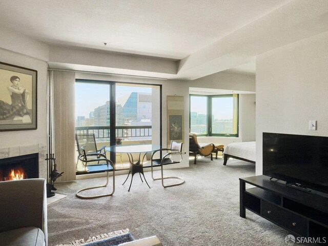 601 Van Ness Ave Unit 1047, San Francisco, CA 94102 - carpeted living room featuring a tile fireplace and healthy amount of natural light
