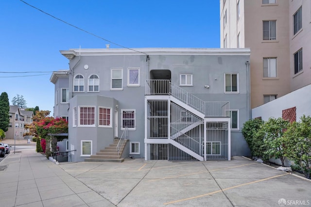 2108 Lakeshore Ave, Oakland, CA 94606 - rear view of property featuring stucco siding and uncovered parking