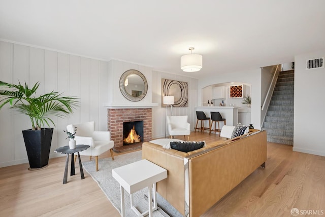 1867 15th Ave, San Francisco, CA 94122 - living area with light wood finished floors, stairs, and a fireplace