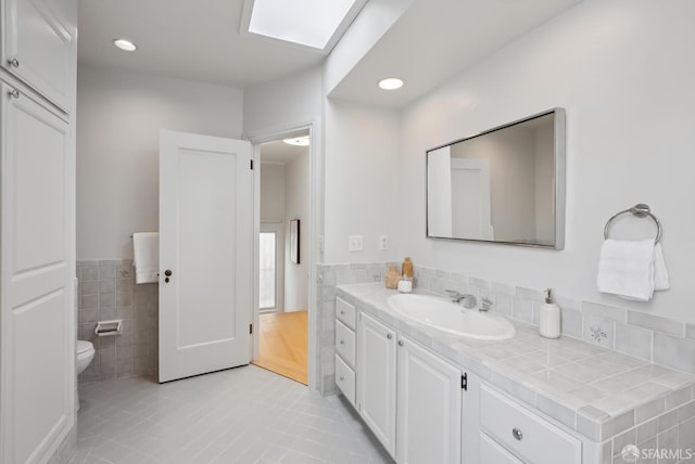 1867 15th Ave, San Francisco, CA 94122 - bathroom with tile walls, tile patterned flooring, vanity, wainscoting, and recessed lighting