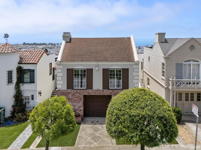 1867 15th Ave, San Francisco, CA 94122 - view of front facade with a chimney, an attached garage, stucco siding, driveway, and brick siding
