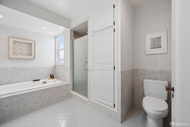 1867 15th Ave, San Francisco, CA 94122 - bathroom with tile patterned flooring, a garden tub, tile walls, a shower stall, and wainscoting