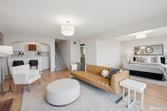 1867 15th Ave, San Francisco, CA 94122 - living room with stairway, light wood-type flooring, and arched walkways