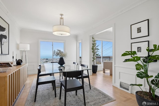 1867 15th Ave, San Francisco, CA 94122 - dining room featuring healthy amount of natural light, crown molding, a decorative wall, and a wainscoted wall