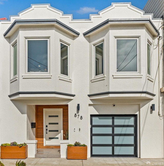 view of front of home featuring a garage and stucco siding