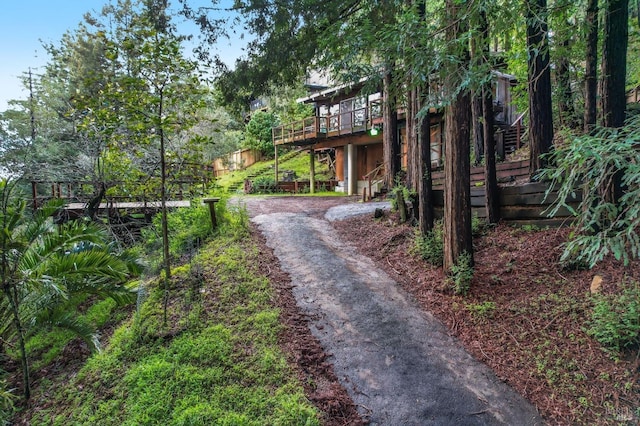 exterior space featuring stairs, driveway, and a deck