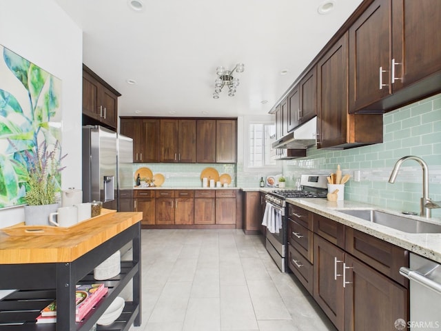 65 Danton St, San Francisco, CA 94112 - kitchen with stainless steel appliances, under cabinet range hood, tasteful backsplash, light tile patterned floors, and recessed lighting