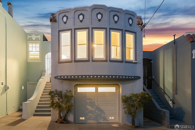 65 Danton St, San Francisco, CA 94112 - view of front of house featuring stairway, stucco siding, and an attached garage