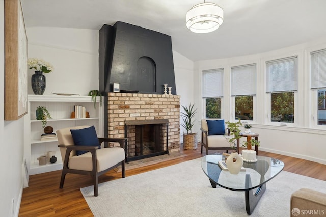 65 Danton St, San Francisco, CA 94112 - living area featuring vaulted ceiling, wood finished floors, and a brick fireplace