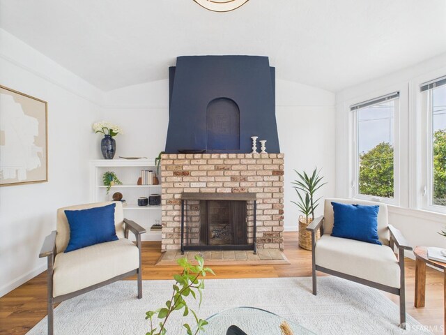 65 Danton St, San Francisco, CA 94112 - living area featuring lofted ceiling, wood finished floors, and a fireplace