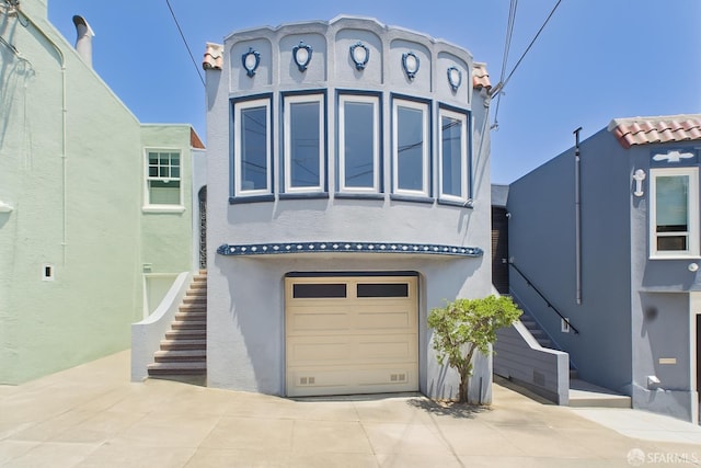 65 Danton St, San Francisco, CA 94112 - view of front of property with stairs, concrete driveway, stucco siding, an attached garage, and a tiled roof