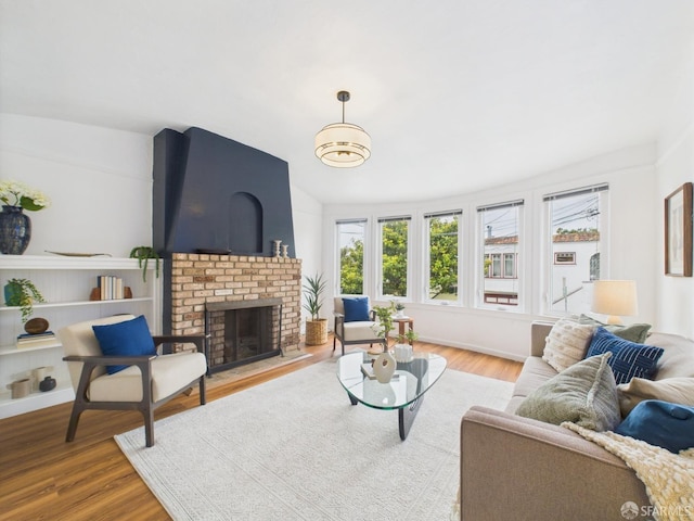 65 Danton St, San Francisco, CA 94112 - living room with wood finished floors, a brick fireplace, and vaulted ceiling