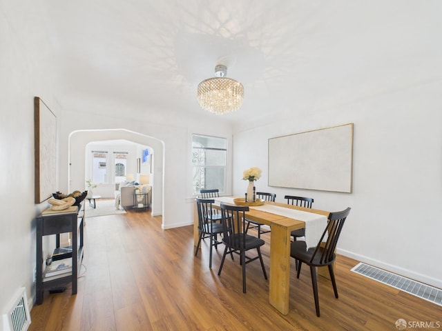65 Danton St, San Francisco, CA 94112 - dining space with arched walkways, wood finished floors, and a chandelier