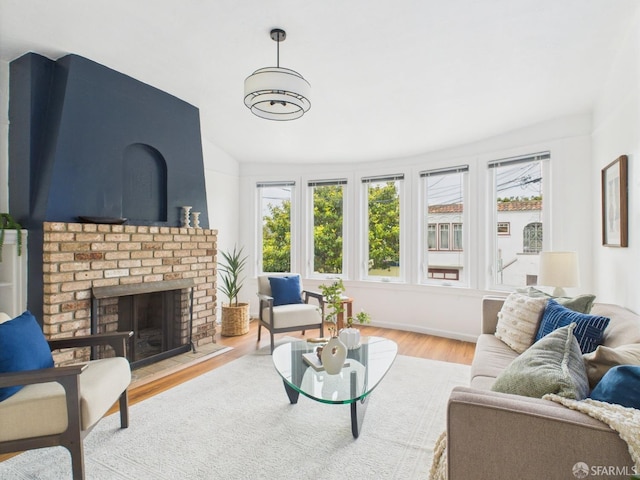 65 Danton St, San Francisco, CA 94112 - living area featuring wood finished floors, a brick fireplace, and lofted ceiling