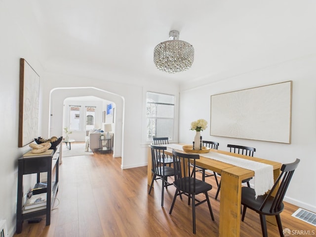 65 Danton St, San Francisco, CA 94112 - dining room with healthy amount of natural light, arched walkways, and wood finished floors