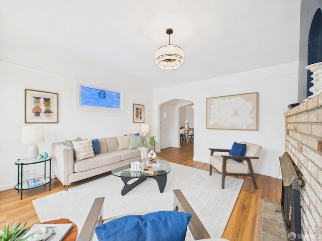 65 Danton St, San Francisco, CA 94112 - living area featuring arched walkways, a fireplace, and wood finished floors
