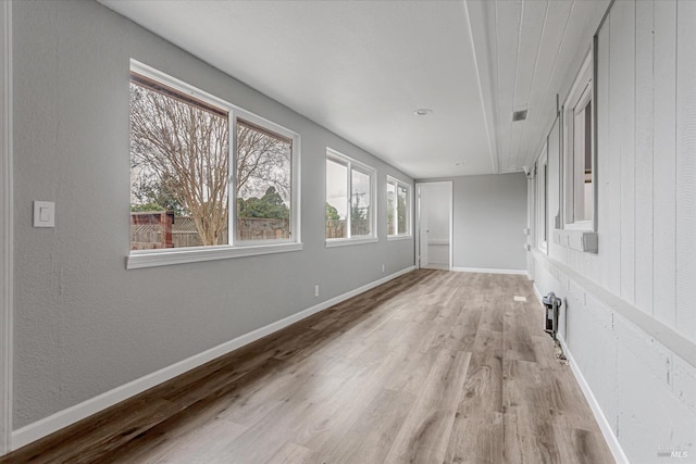 unfurnished sunroom with visible vents