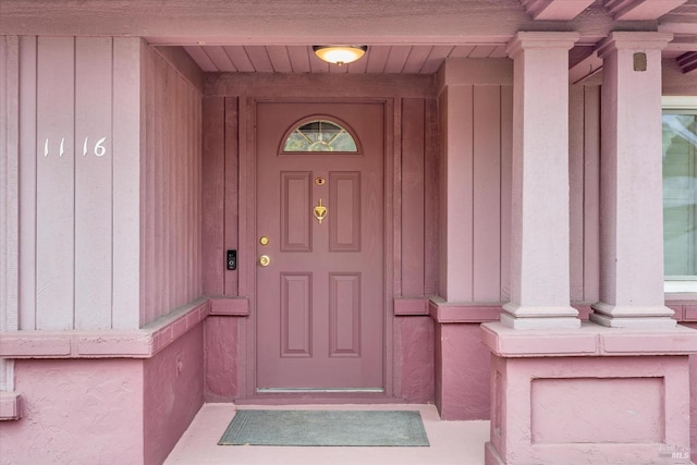 view of exterior entry featuring board and batten siding