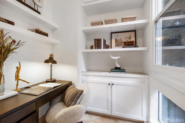 office space featuring light tile patterned floors and built in shelves