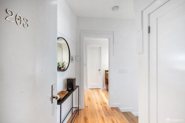 corridor with light wood-type flooring