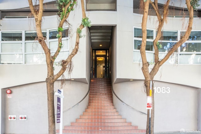 doorway to property featuring stucco siding