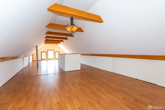 bonus room with vaulted ceiling with beams and light hardwood / wood-style flooring