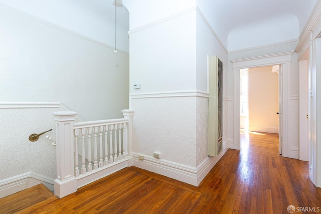 hall featuring ornamental molding and dark wood-type flooring