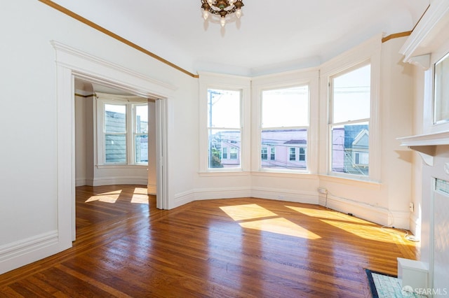 unfurnished dining area with crown molding and wood-type flooring