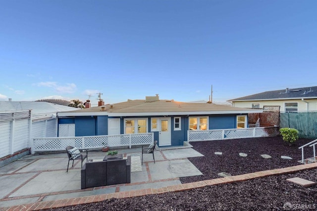 view of front of house featuring a patio and fence