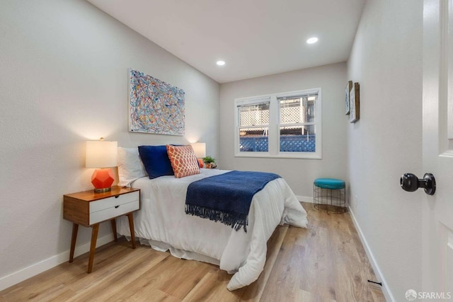 bedroom with recessed lighting, baseboards, and light wood finished floors