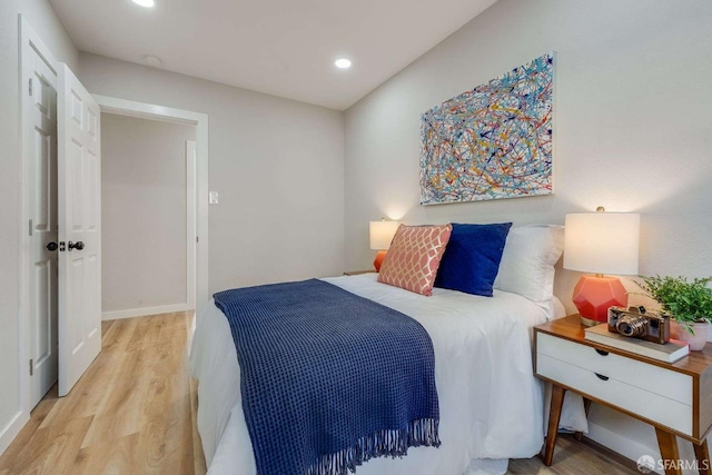 bedroom featuring recessed lighting, light wood-style flooring, and baseboards