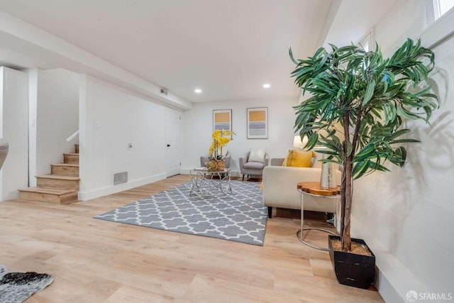 sitting room with stairway, recessed lighting, wood finished floors, and visible vents