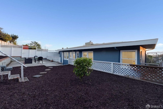 back of house with a patio and fence