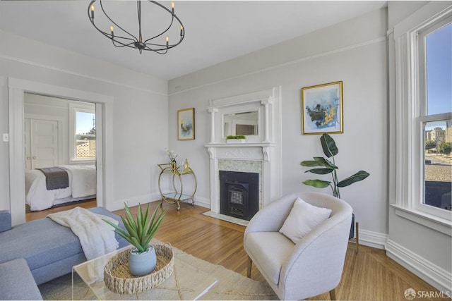 living room with an inviting chandelier and hardwood / wood-style flooring