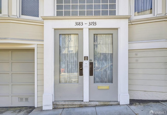 doorway to property with a garage