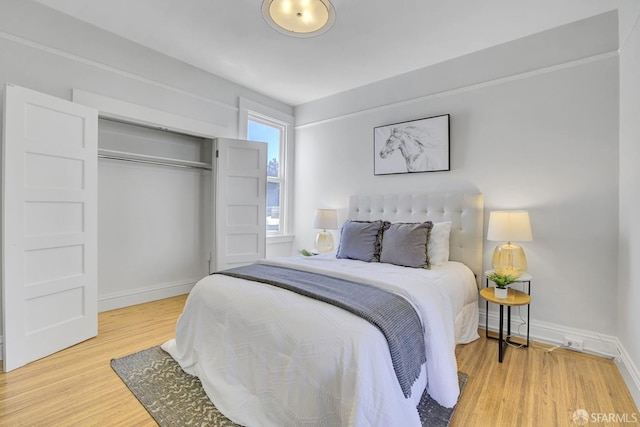 bedroom with hardwood / wood-style floors and a closet