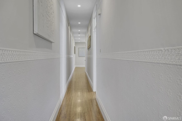 hallway with light hardwood / wood-style flooring