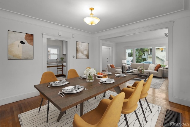 dining space with light wood-style floors and baseboards