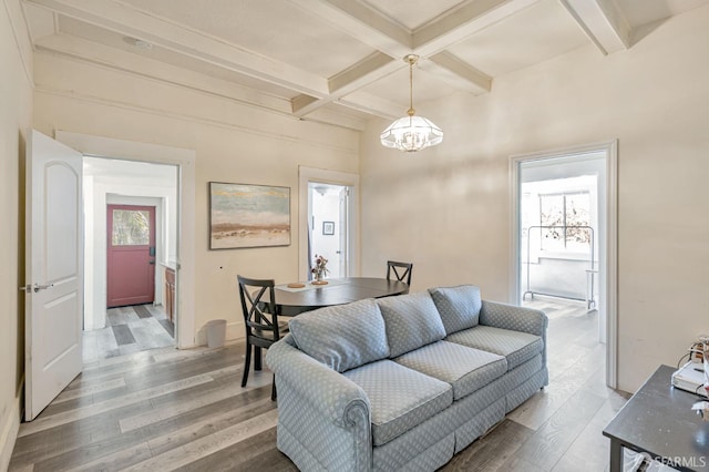 3233 Ellis St, Berkeley, CA 94703 - living room featuring beamed ceiling, light wood-style flooring, a chandelier, and coffered ceiling