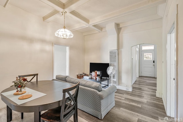 3233 Ellis St, Berkeley, CA 94703 - dining space featuring a heating unit, coffered ceiling, a chandelier, wood finished floors, and beamed ceiling