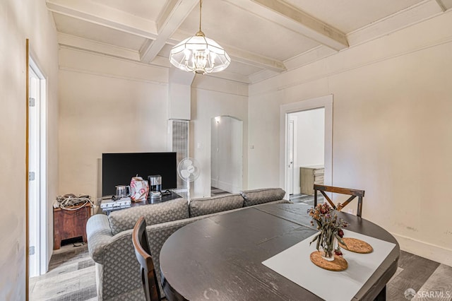3233 Ellis St, Berkeley, CA 94703 - dining area with a chandelier, wood finished floors, beamed ceiling, arched walkways, and baseboards
