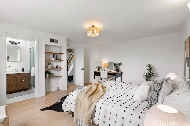 bedroom with visible vents and light wood finished floors