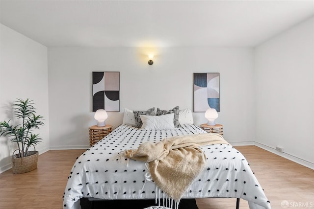 bedroom with wood finished floors and baseboards