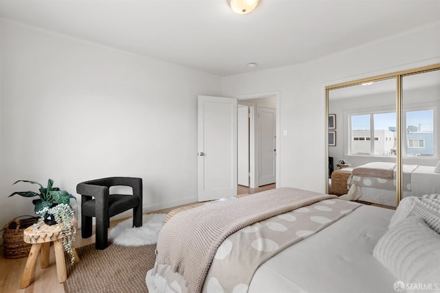 bedroom with baseboards, a closet, and ornamental molding