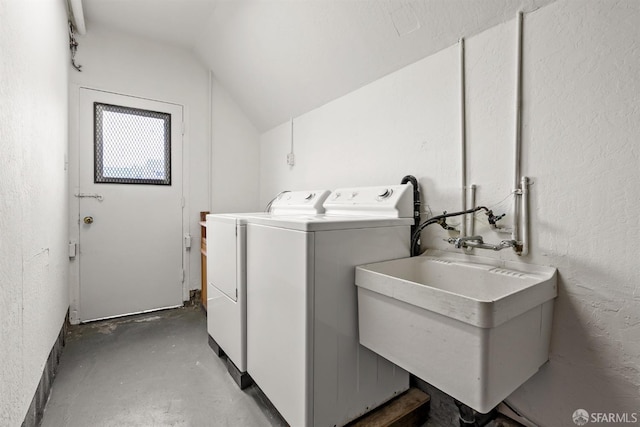 clothes washing area with laundry area, a sink, and washing machine and clothes dryer