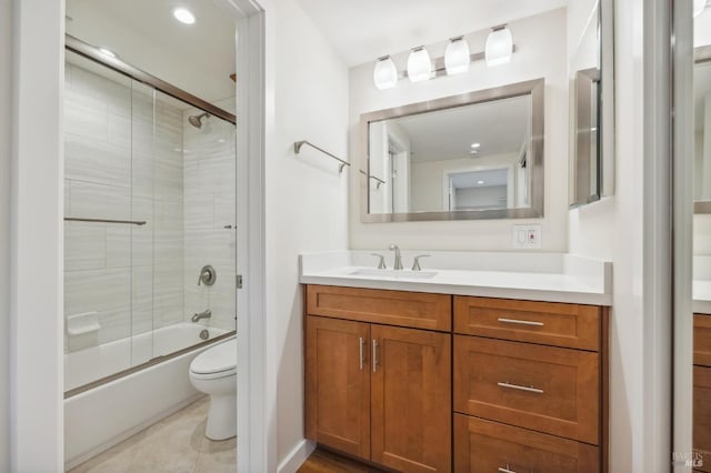 full bathroom with tile patterned floors, vanity, enclosed tub / shower combo, and toilet