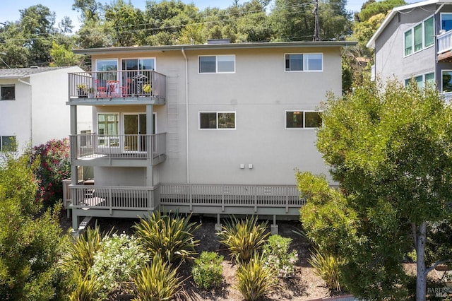 back of property with a balcony